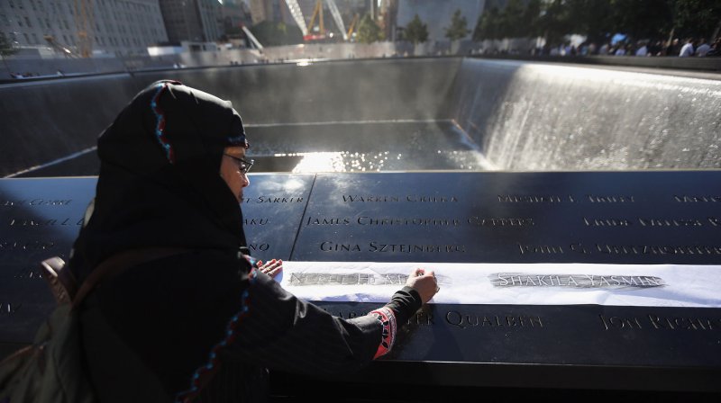Khudeza Begum etches the name of her slain nephew at ceremonies for the eleventh anniversary of the terrorist attacks on lower Manhattan at the World Trade Center on September 11, 2012 in New York City. Begum, who is from Bangladesh, lost her neffew Nural Miah and his wife Shakila Yasmin, two of the many Muslims who also died the 9/11 attacks. UPI/John Moore/Pool