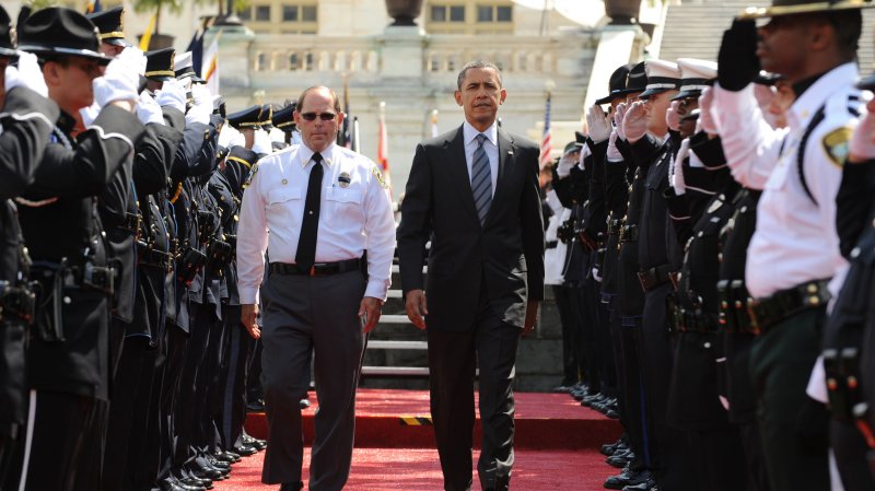 US President Barack Obama (R) and President Grand Lodge Fraternal Order of Police Chuck Canterbury (L), walk past an honor guard during the National Peace Officers Memorial Service, an annual ceremony honoring law enforcement who were killed in the line of duty, on Capitol Hill in Washington DC, on May 15, 2012. UPI/Michael Reynolds/Pool