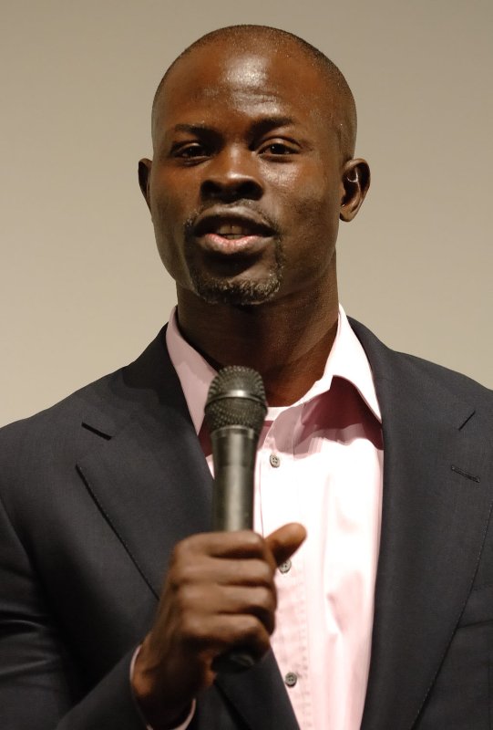 In promoting an action-charged movie 'Blood Diamond', focusing on the dark side of diamond business in conflict-ridden Sierra Leone, Africa, Djimon Hounsou, himself born in west African nation of Benin, greets the audience during the film's Japan Premiere in Tokyo, Japan, on April 5, 2007. (UPI Photo/Keizo Mori)