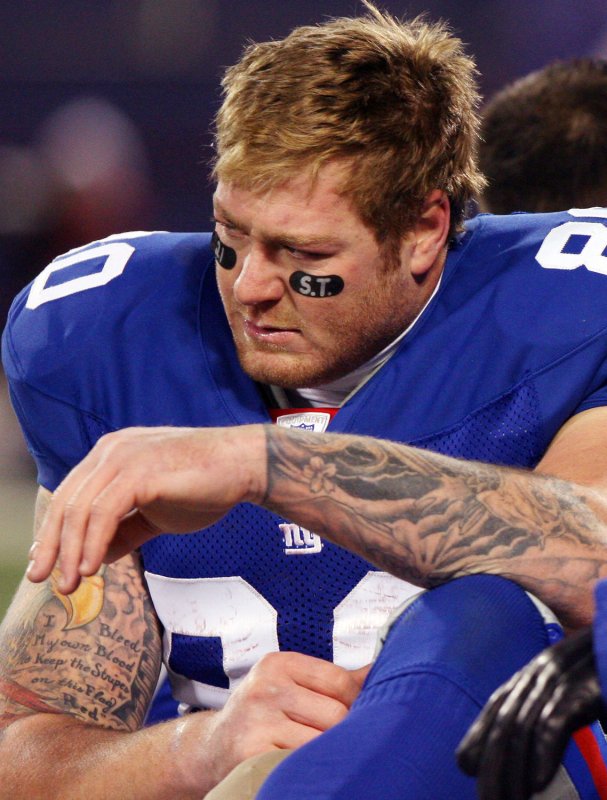 New York Giants Jeremy Shockey reacts while being carted off of the field with an injured ankle in the third quarter against the Washington Redskins at Giants Stadium in East Rutherford, New Jersey on December 16, 2007. The Washington Redskins defeated the New York Giants 22-10. (UPI Photo/John Angelillo) . | <a href="/News_Photos/lp/f036ae6d49f1ef39b8899e35fe32c9b8/" target="_blank">License Photo</a>