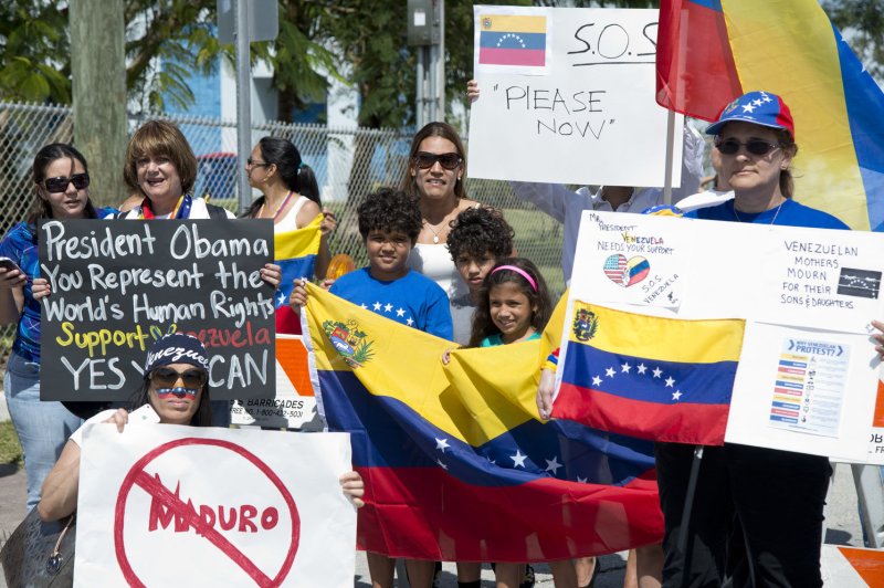 Venezuela protesters demonstrate outside of the Coral Reef High School in Miami, Florida, March 7, 2014. (UPI/Gary I Rothstein) | <a href="/News_Photos/lp/50b7458c2fba349089d640313dc86e91/" target="_blank">License Photo</a>
