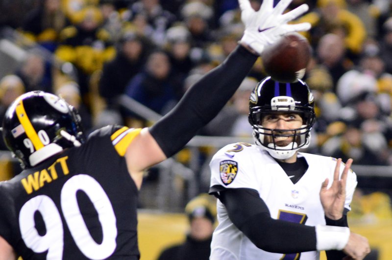 Baltimore Ravens quarterback Joe Flacco (5) throws past the hand of Pittsburgh Steelers outside linebacker T.J. Watt (90) in the first quarter on December 10 at Heinz Field in Pittsburgh. Photo by Archie Carpenter/UPI