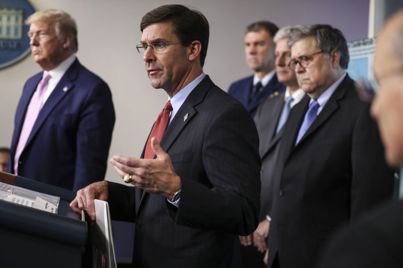 Defense Secretary Mark Esper, center, shown here at an April 1 White House briefing, has proposed shifting funds from overseas military construction in order to finance domestic construction projects paused in favor of the border wall. Photo by Oliver Contreras/UPI