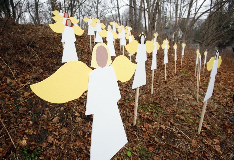 26 wooden angels representing the 26 victims are staked into the ground near Sandy Hook Elementary School in Newtown, Connecticut, on December 14, 2012 following a shooting that left 26 people dead including 20 children on December 14, 2012. UPI/John Angelillo