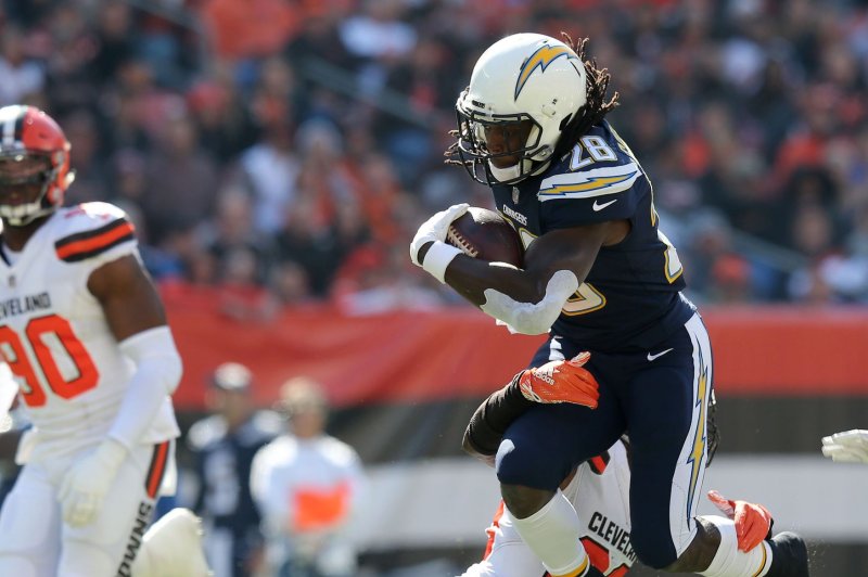 Los Angeles Chargers running back Melvin Gordon III attempts to jump over Cleveland Browns defender Damarious Randall on October 14, 2018 at FirstEnergy Stadium in Cleveland, Ohio. Photo by Aaron Josefczyk/UPI
