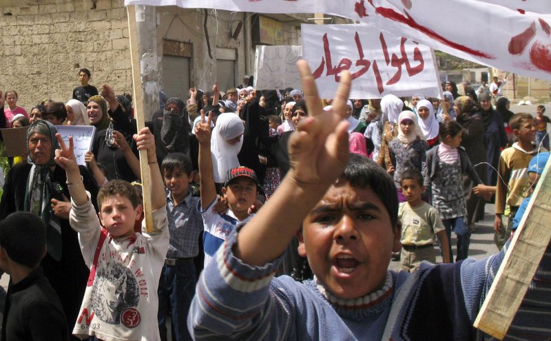 Mothers, wives, sisters and children of Syrian anti-government men who were arrested by the security forces hold banners and shout slogans during a protest demanding to release them in the town of Nawa, Darra city, Syria, on May 4, 2011. UPI