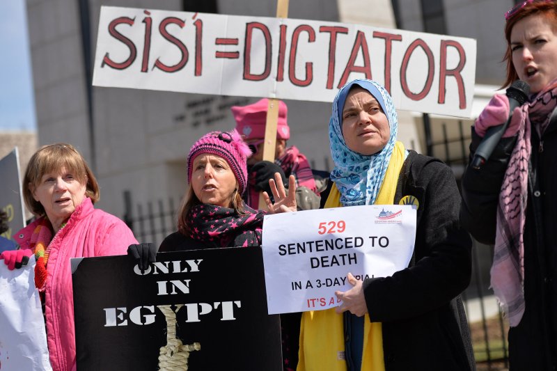 Member's of the activist group CODEPINK and the Egyptian Americans for Democracy and Human Rights group rallied outside of the Egyptian Embassy on March 27, 2014 calling for the Egyptian government to reverse the death sentences handed down to 529 Egyptians in a mass two-day trial. (UPI/Kevin Dietsch) | <a href="/News_Photos/lp/a4cc04171240118f35dfccece385932e/" target="_blank">License Photo</a>