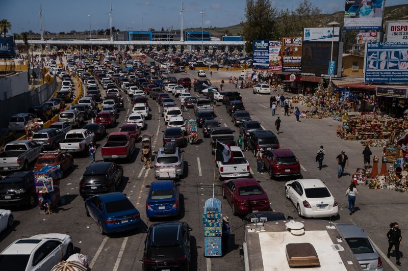 Vehicles wait in line at the Mexico-Unites States border to leave Tijuana, Mexico, and enter the United States in March 2021. File Photo by Ariana Drehsler/UPI