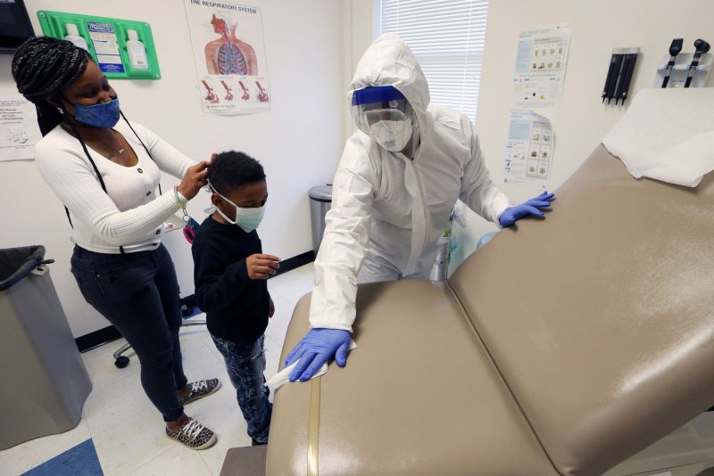 A mother and her eight year-old son are tested for the coronavirus at a site in St. Louis, Mo., on Monday. Photo by Bill Greenblatt/UPI