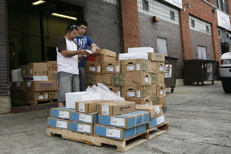 A worker and customer discuss a sale in the Fulton Market meatpacking district in Chicago. The Labor Department reported Friday a 0.2 percent drop in the Producer Price Index, which reflects the price of goods before they reach store shelves. (UPI Photo/Brian Kersey)