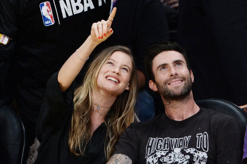 Adam Levine (R) and Behati Prinsloo attend Kobe Bryant's final game with the Los Angeles Lakers on April 13. The couple welcomed their first child in September. File Photo by Jim Ruymen/UPI
