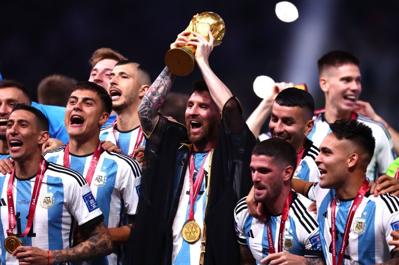 Lionel Messi of Argentina lifts the FIFA World Cup trophy with his teammates at Lusail Stadium in Lusail City, Qatar, on Sunday. Photo by Chris Brunskill/UPI