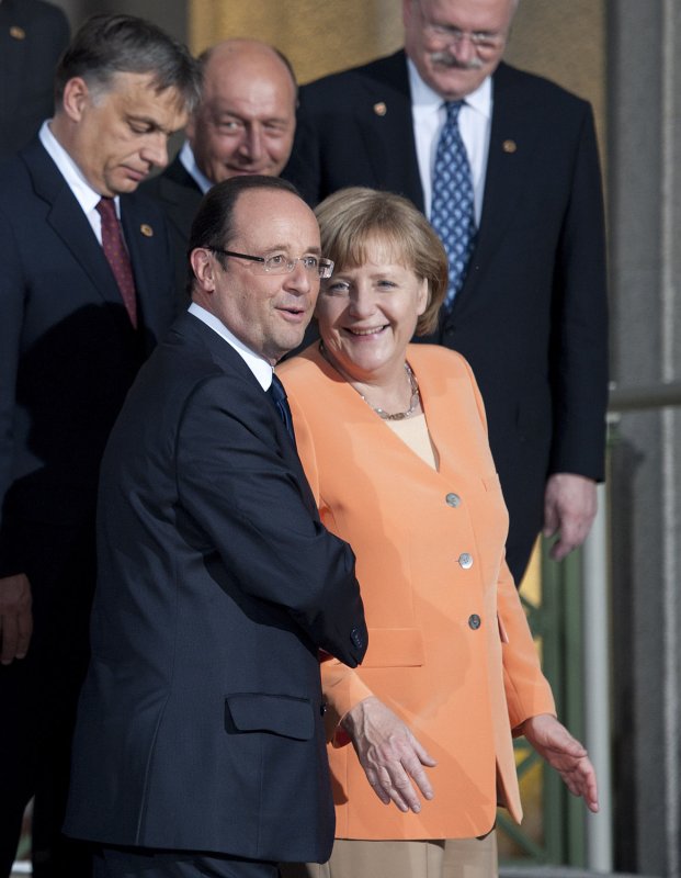 French President Francois Hollande (L) is shown with German Chancellor Angela Merkel at a NATO meeting in 2012. The two have severe differences in leading their countries' economies. UPI/Brian Kersey