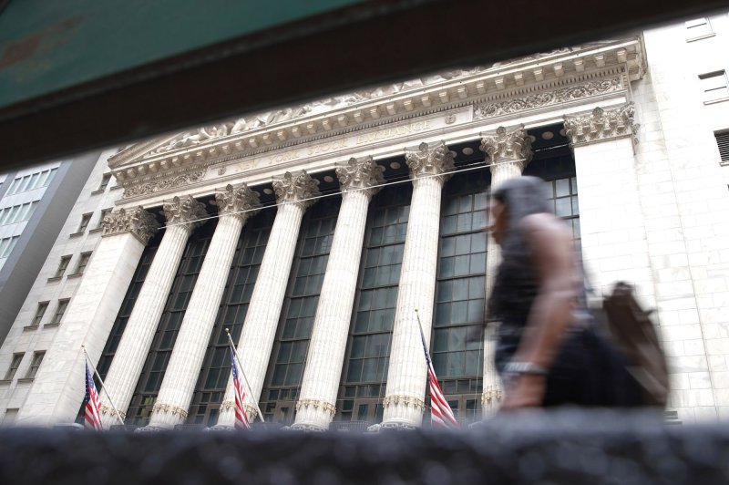 A pedestrian walks past the New York Stock Exchange on Wednesday, on Wall Street in New York City. Photo by John Angelillo/UPI