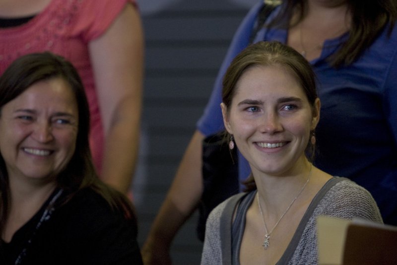 Amanda Knox, right, and her mother Edda smile at a crowd of supporters during a news conference held at the Seattle-Tacoma International Airport when she came home on October 4, 2011. The European Court of Human Rights ordered Italy to pay Knox damages. Photo by Jim Bryant/UPI