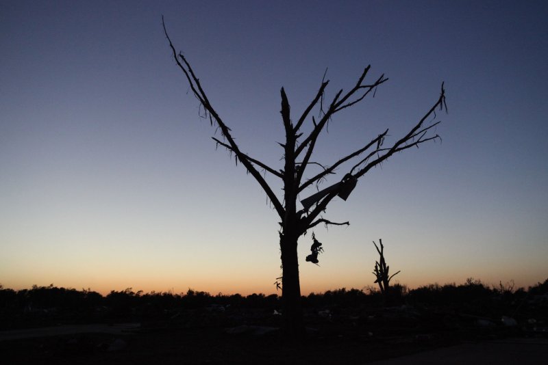 The sun sets behind tornado debris in Moore, Oklahoma on May 22, 2013. UPI/J.P. Wilson