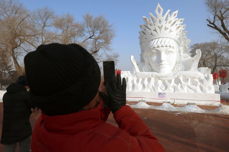 A tourist takes a picture of a snow sculpture during the 33rd Harbin International Ice and Snow Sculpture Festival in Harbin, the capital of China's Northeastern Heilongjiang rovince, on January 7. On November 22, 1972, the U.S. State Department ended a 22-year ban on U.S. travel to China. File Photo by Stephen Shaver/UPI | <a href="/News_Photos/lp/99166cba61676d76bbc3101a99ff1e5b/" target="_blank">License Photo</a>