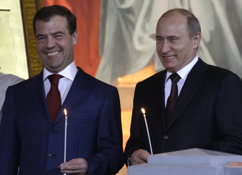 Russian President Dmitry Medvedev (L)and Prime Minister Vladimir Putin smile during night Easter service in the Christ the Savior Cathedral in Moscow on April 19, 2009. (UPI Photo/Anatoli Zhdanov)