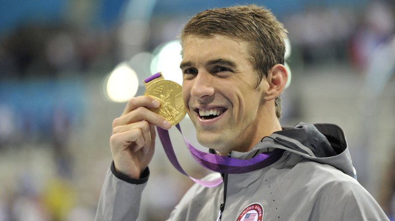 Michael Phelps of the United States holds his Gold Medal for the Men's 4 X 200M Freestyle Relay Final after the medal ceremony at the London 2012 Summer Olympics on July 31, 2012 in Stratford, London. The United States team of Ryan Lochte, Conor Dwyer, Ricky Berens and Michael Phelps won Gold with a time of 6:59.70 in the relay. UPI/Brian Kersey