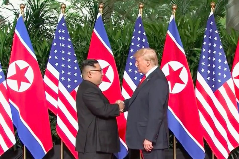 A new North Korean biography of Kim Jong Un mentions Kim's summit with former U.S. President Donald Trump (R) but makes no references to South Korean President Moon Jae-in. File Photo from Pool TV/UPI | <a href="/News_Photos/lp/e115d021453080aaf5ebc3633cd6eb87/" target="_blank">License Photo</a>