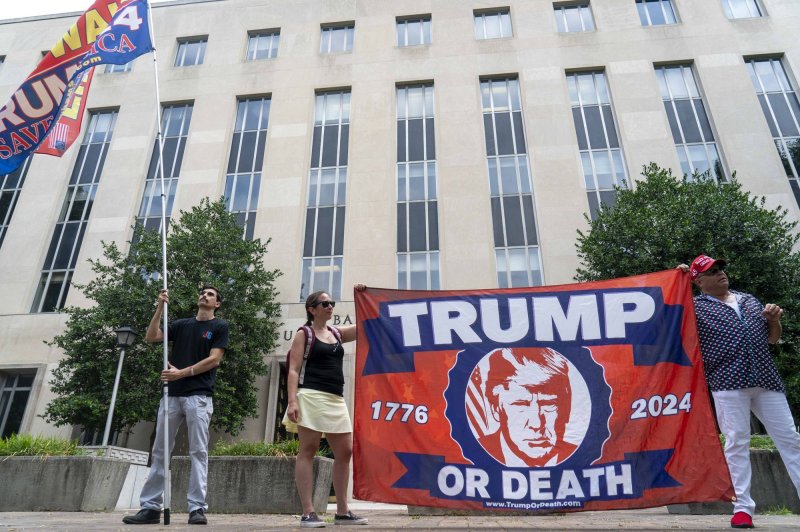 Supporters of former President Donald Trump holds flags outside the E. Barrett Prettyman Federal Courthouse before his arraignment on charges of election subversion, in Washington DC, on Thursday, August 3, 2023. Special counsel Jack Smith has indicted the former president on four charges in connection with his actions leading up to and after the January 6 attack on the U.S. Capitol. Photo by Bonnie Cash/UPI