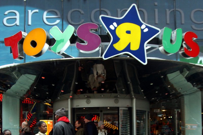 People walk past the New York flagship store for Toys 'R' Us. in Times Square. As the chain gets ready to close its doors, employees are demanding the company pay them $15,000 in severance. File Photo by Ezio Petersen/UPI