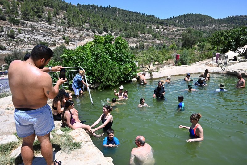 Israelis cool off in a pool from the Byzantine Period with water from the Haniya Natural Spring in the Judean Mountains National Park in the West Bank on July 15 as the Israeli weather service issued a severe heat stress warning. Photo by Debbie Hill/ UPI