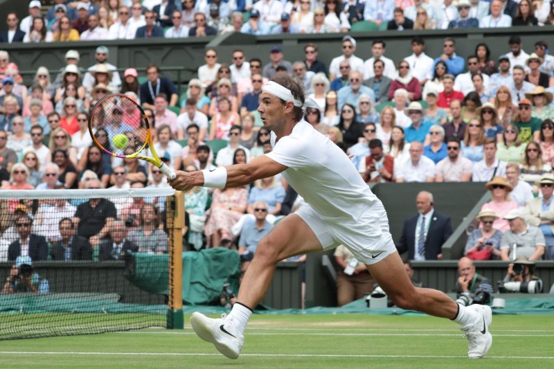 Spain's Rafael Nadal plays a forehand against American Taylor Fritz at Wimbledon 2022 on Wednesday in London. Photo by Hugo Philpott/UPI | <a href="/News_Photos/lp/f02485a46f10fc72af8766fc36c4c322/" target="_blank">License Photo</a>