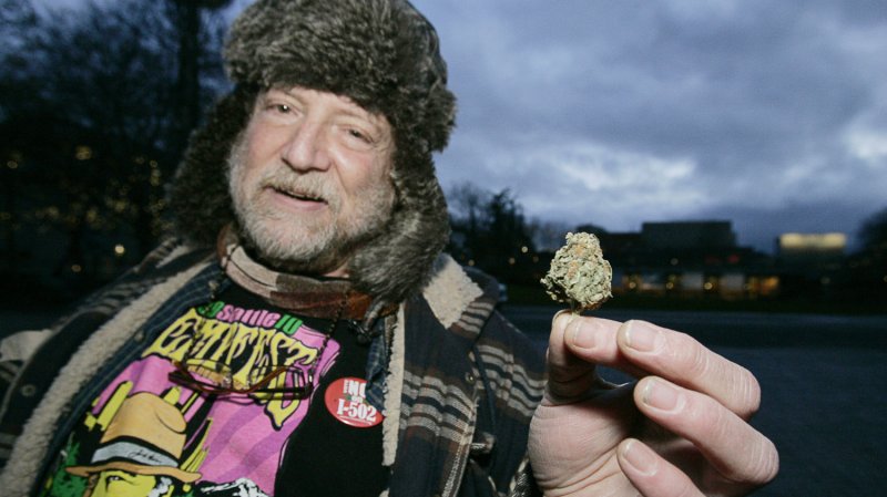 Michael Dare, a medical marijuana user, displays a bud during a public consumption of marijuana rally at the Seattle Center on December 6, 2012 in Seattle. Despite the new law's ban on public marijuana use which is subject to a fine of about $50.00 many showed up for the smoke-in. In November, Washington state jumped into history becoming the first state along with Colorado to reject federal drug-control policy and legalize recreational marijuana use. UPI/Jim Bryant