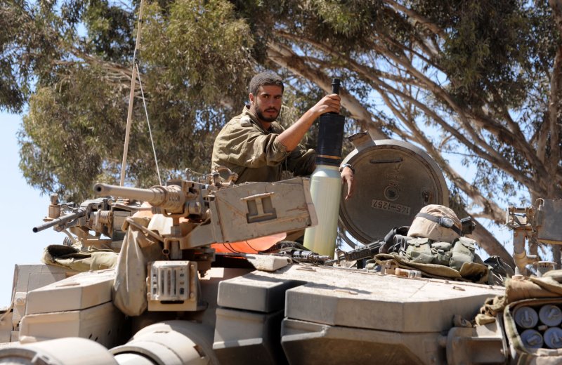 An Israeli soldier holds a shell on top of a Merkava tank at a staging area near the Israel and Hamas controlled Gaza Strip border in southern Israel, July 31, 2014. UPI/Debbie Hill