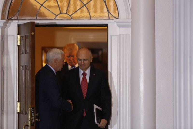 Andrew Puzder, chief executive of CKE Restaurants, pictured shaking Vice President Mike Pence's hand after a meeting with him and President Donald Trump in November, said Monday that he and his wife previously employed an undocumented immigrant as a housekeeper but fired her when they found out. The allegation has derailed previous nominations for secretary of labor but members of the Trump administration feel confident that old standards for following such rules will not apply. Pool Photo by Peter Foley/UPI
