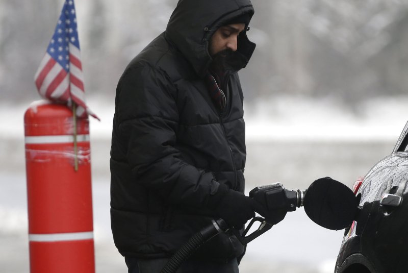 A gas station attendant services a customer in Hoboken, New Jersey on January 24, 2015. Oil prices dropped Tuesday as gasoline prices tumbled. File Photo by John Angelillo/UPI