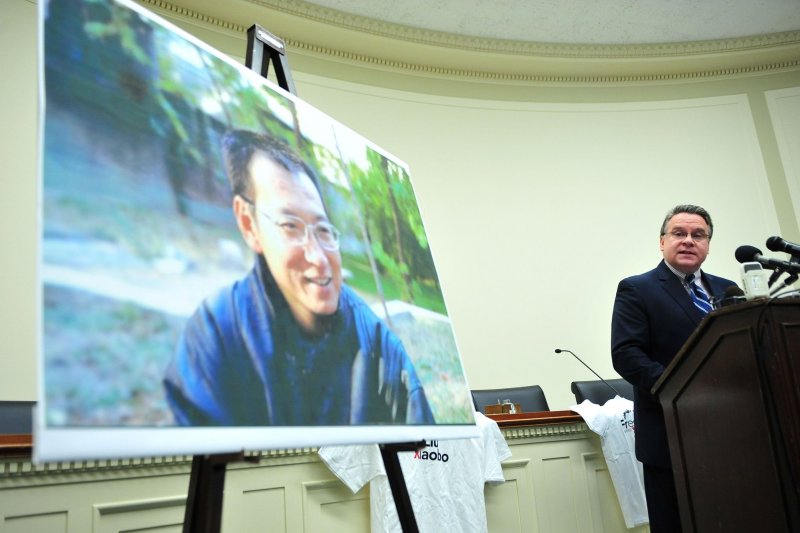 U.S. Rep. Christopher Smith, R-N.J., spoke at a Washington pro-democracy rally honoring Nobel Peace Prize Laureate Liu Xiaobo, depicted in the portrait. Liu, battling terminal liver cancer until his death on Thursday, was given medical parole from a Chinese prison last month. File Photo by Kevin Dietsch/UPI | <a href="/News_Photos/lp/3b2b5317353552f2cbe5d0edce574456/" target="_blank">License Photo</a>