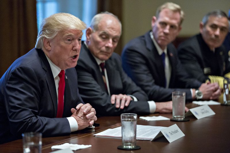 President Donald Trump speaks as John Kelly, White House chief of staff, to his left, listens during a briefing with senior military leaders in the Cabinet Room of the White House on Thursday. Photo by Andrew Harrer/UPI