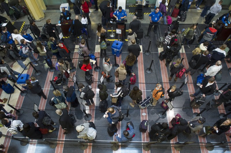 Travelers wait in line at a TSA security checkpoint at Ronald Reagan National airport. UPI/Kevin Dietsch
