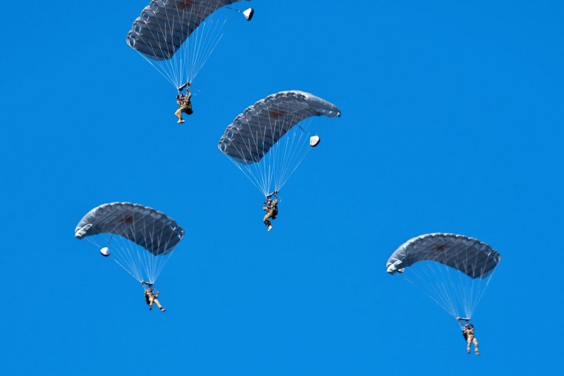 Soldiers of U.S., Britain and Australian Army are seen come down in a parachute during the New year drill by the Japan's GSDF 1st Airborne Brigade at Narashino Training Area in Chiba-Prefecture, Japan on Sunday. Photo by Keizo Mori/UPI
