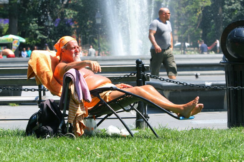 A man gets some sun in Washington Square Park as temperatures approached the triple digit mark during a heat wave in New York. UPI/Monika Graff | <a href="/News_Photos/lp/4ca6bd4adf86c189ac9b0d000a3c7fd5/" target="_blank">License Photo</a>