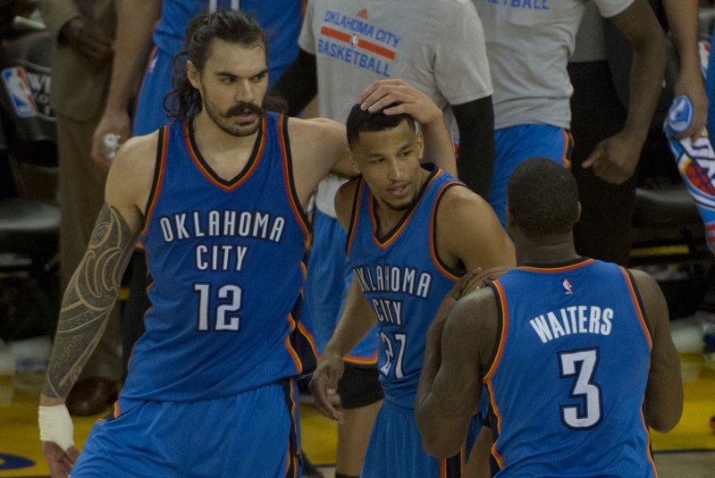Oklahoma City Thunder's Steven Adams (12).celebrates with Andre Roberson (21) and Dion Waiters (3) after upsetting the Golden State Warriors in game 1 of the NBA Western Conference Finals at Oracle Arena in Oakland, California on May 16, 2016. The Thunder defeated the Warriors 108-102. Photo by Terry Schmitt/UPI | <a href="/News_Photos/lp/c7e4bd270e89157420afaaa9a2d3bf1f/" target="_blank">License Photo</a>