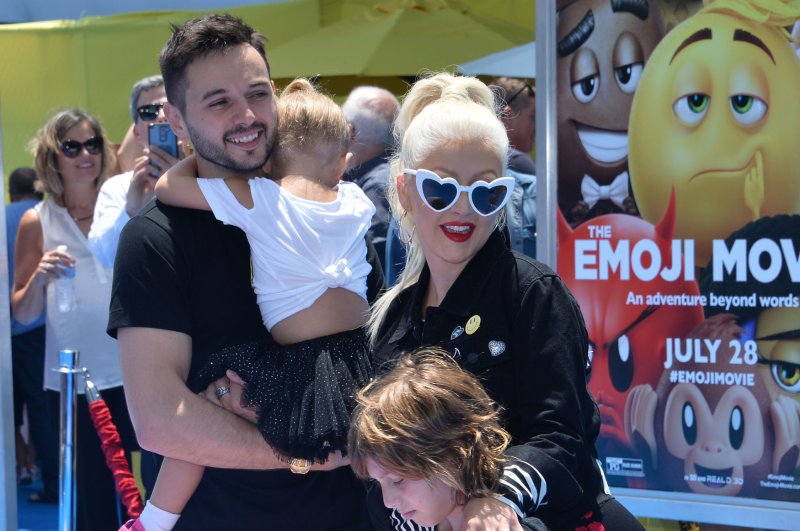 Christina Aguilera (R), pictured with Matthew Rutler and her kids, slammed "The Voice" in a new interview. File Photo by Jim Ruymen/UPI
