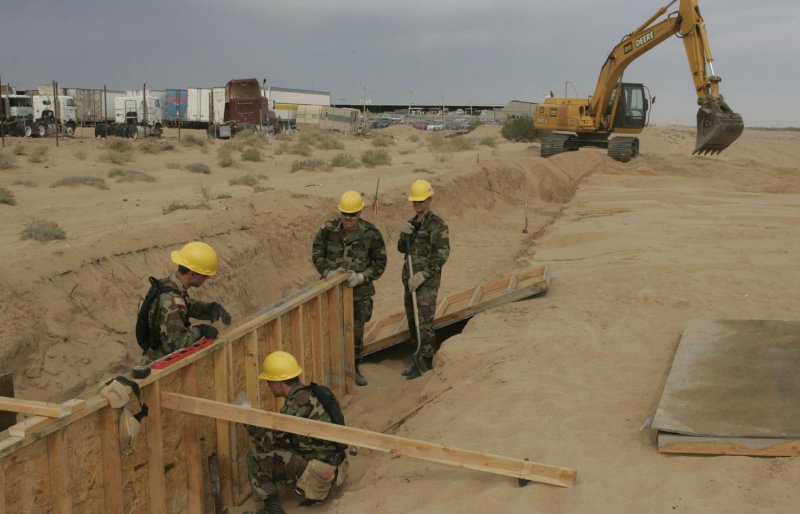 Utah National Guard members Thomas Carter of Roosevelt, Utah; Joshua Richards of Layton, Utah; Brad Young of Toowillow, Utah; and Staff Sgt John Bylsma of Pleasant Grove, Utah install concrete forms to support the fence at the Arizona border with Mexico in San Luis, Arizona June 6, 2006. More than 50 National Guardsmen from Utah became the first unit to get to work under President George W. Bush's crackdown on illegal immigration. (UPI Photo/Will Powers)