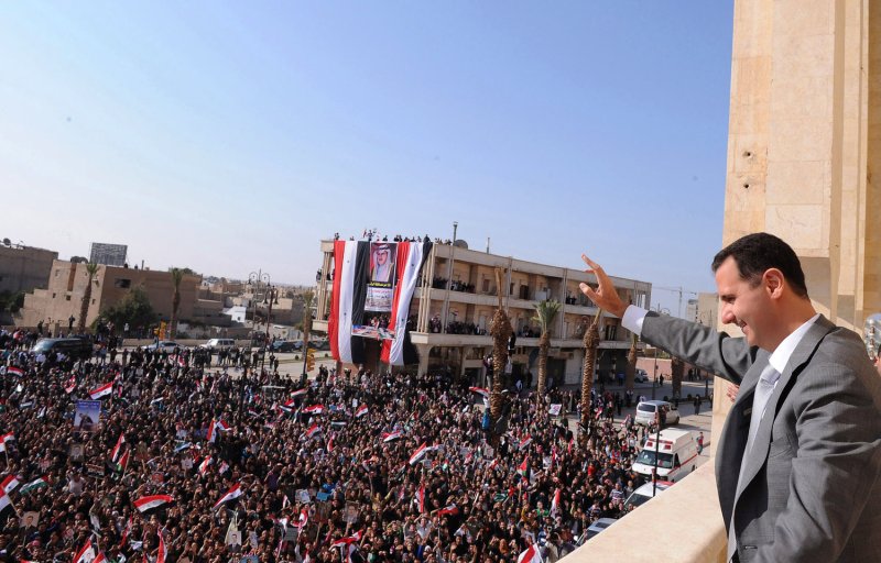 Syria's President Bashar al-Assad greets the crowd during his visit to Raqqa city in Eastern Syria, November 6, 2011, in this handout photograph released by Syria's national news agency. UPI | <a href="/News_Photos/lp/0b83da126393c00eacae59e424711b3b/" target="_blank">License Photo</a>