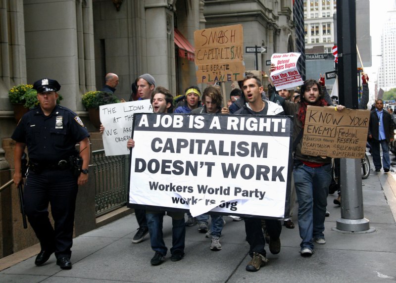 Demonstrators march though the Financial District under a heavy police presence as they protest the economic system on September 20, 2011 in New York City. People are taking part in the multi-day protest organized by "Occupy Wall Street" by camping out in near-by Zuccotti Park and marching through the financial district as people make their way to work. UPI/Monika Graff