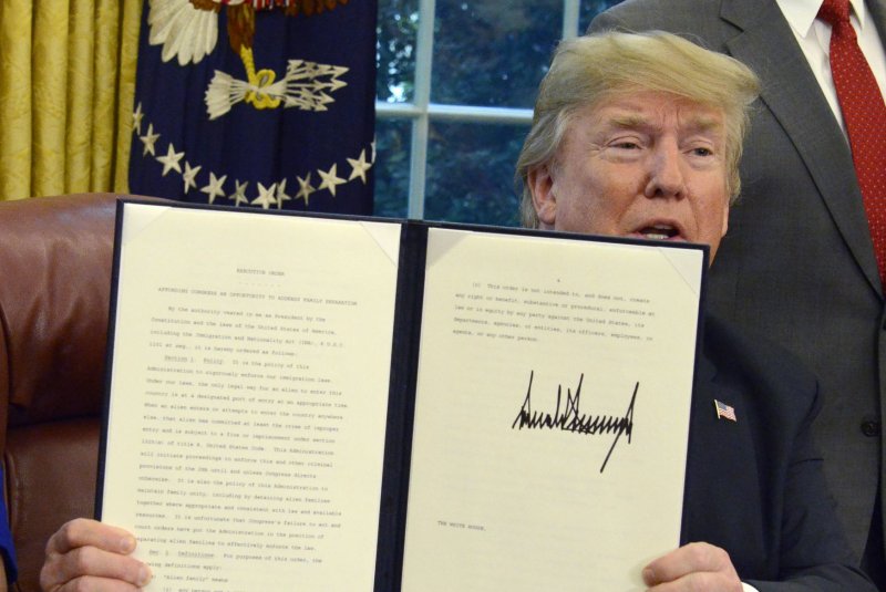 President Donald Trump displays the executive order to stop the separation of immigration families, the result of his crackdown on illegal border crossing. Photo by Mike Theiler/UPI