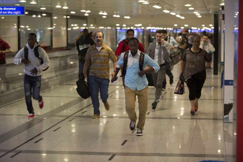 Turkish police arrested 13 people in connection to the attack on Istanbul Ataturk Airport that left at least 42 dead and hundreds injured. Pictured, travelers at the airport flee after two explosions followed by gunfire hit Turkey's biggest airport, killing dozens and injuring many on Tuesday in Istanbul. Photo by Laurance Cameron/UPI