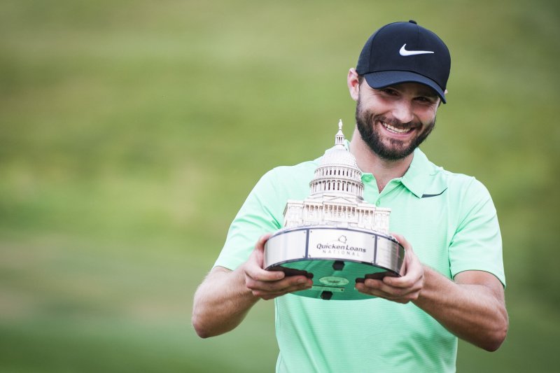 Champion Kyle Stanley holds the trophy after he won the Quicken Loans National at TPC Potomac at Avenel Farm on July 2, 2017 in Potomac, Md. Stanley won the tournament with a par in the first playoff hole against Charles Howell III. Photo by Pete Marovich/UPI