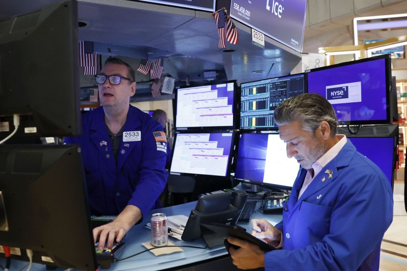 Traders work on the floor of the NYSE before the opening bell at the New York Stock Exchange on Wall Street in New York City on August 19. Stocks fell for a third straight week Friday. Photo by John Angelillo/UPI | <a href="/News_Photos/lp/aafe422e8cab402c957dfcbc1c50226f/" target="_blank">License Photo</a>