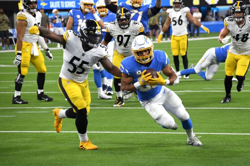 Los Angeles Chargers running back Austin Ekeler (R) scores in front of Pittsburgh Steelers linebacker Devin Bush in the second quarter Sunday at SoFi Stadium in Inglewood, Calif. Photo by Jon SooHoo/UPI