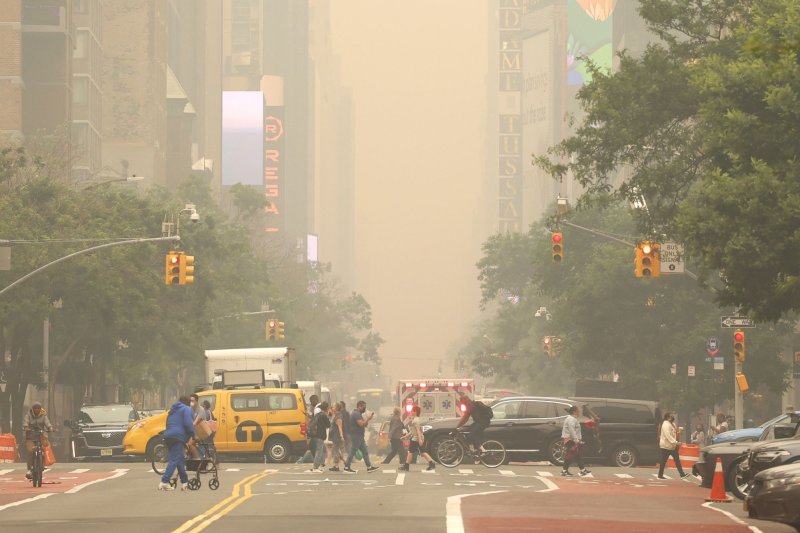 Pedestrians cross 42nd Street as it is enveloped in smoke from continued wildfires in Canada on Wednesday in New York City. Several Broadway shows were canceled due to the smoke. Photo by John Angelillo/UPI