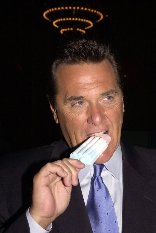NYP2002070213 - NEW YORK, July 2 (UPI) -- Legendary game show host Chuck Woolery eats ice cream while awaiting the judges' decision on July 2, 2002 for the winner of the 2002 Dove Deodorant national contest for America's Most Beautiful Underarms. rlw/ep/Ezio Petersen UPI