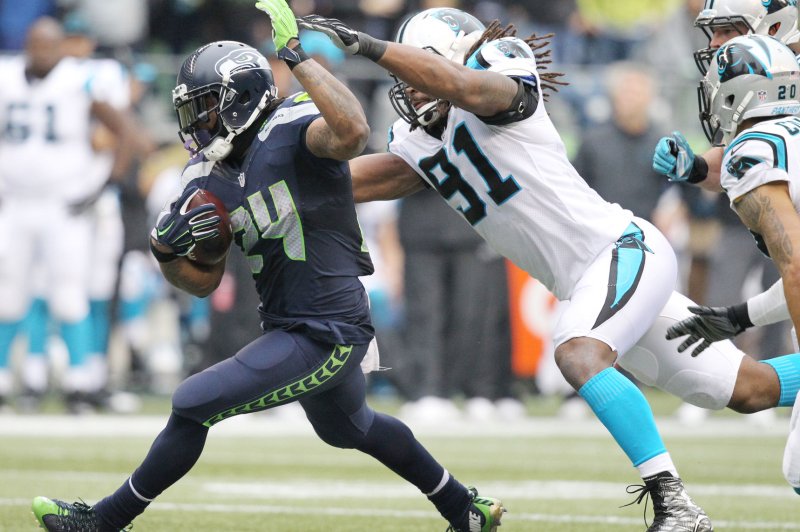 Former Seattle Seahawks running back Marshawn Lynch runs away from former Carolina Panthers defensive end Ryan Delaire (91) in 2015 at CenturyLink Field in Seattle. File photo by Jim Bryant/UPI